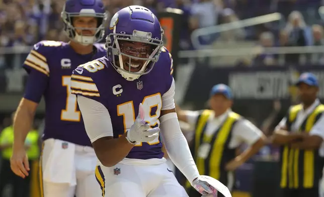 Minnesota Vikings wide receiver Justin Jefferson (18) celebrates after catching a touchdown pass during the first half of an NFL football game against the Houston Texans, Sunday, Sept. 22, 2024, in Minneapolis. (AP Photo/Bruce Kluckhohn)