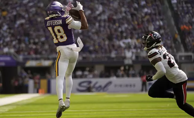 Minnesota Vikings wide receiver Justin Jefferson (18) catches a pass over Houston Texans cornerback Derek Stingley Jr. (24) during the first half of an NFL football game, Sunday, Sept. 22, 2024, in Minneapolis. (AP Photo/Abbie Parr)