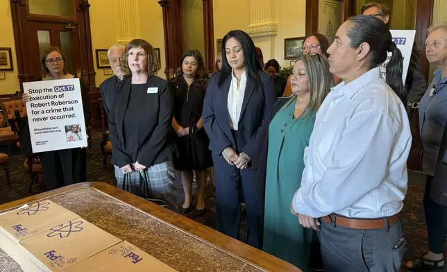 Elizabeth Ramirez, center, Casandra Rivera, center right, and Anna Vasquez, second from right, of the "San Antonio 4" group, deliver boxes with petitions in the Texas State capitol for Texas Gov. Greg Abbott seeking the pardoning of Robert Roberson's execution, Wednesday, Oct. 16, 2024, in Austin, Texas. Roberson, 57, is scheduled to receive a lethal injection on Oct. 17, for the 2002 killing of his 2-year-old daughter, Nikki Curtis, in the East Texas city of Palestine. Roberson has long proclaimed his innocence. (AP Photo/Nadia Lathan)