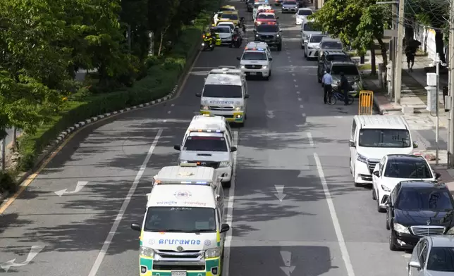 Ambulances carrying bodies of victims of a school bus fire leave from the Police hospital in Bangkok, Thailand, Wednesday, Oct. 2, 2024. (AP Photo/Sakchai Lalit)