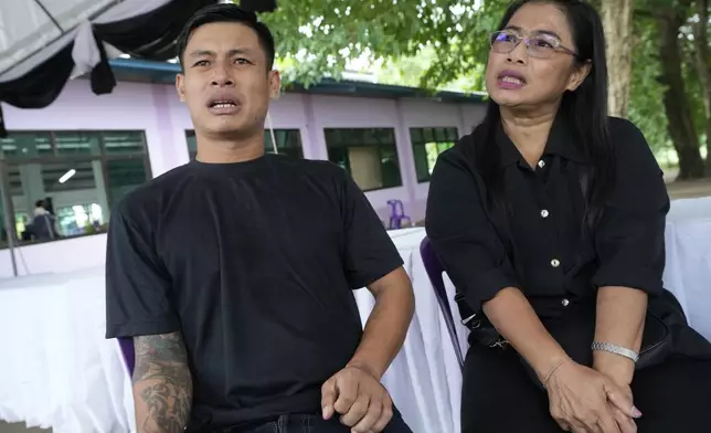 Father, Wichan Seubsaichan, left and grandmother Noklek Seekham of one of the victims of the school bus fire talk during an interview with the Associated Press at Wat Khao Phraya Sangkharam School, Lan Sak, Uthai Thani province, Thailand, Thursday, Oct. 3, 2024. (AP Photo/Sakchai Lalit)