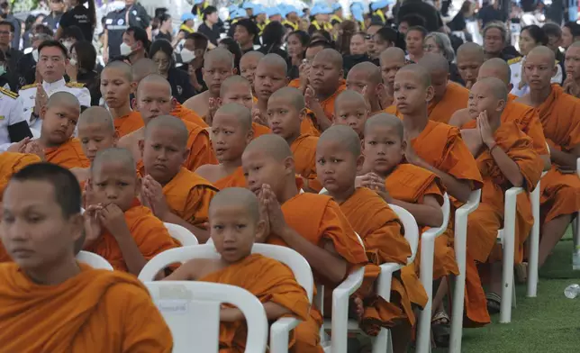 Young monks attend a memorial service for victims of a school bus fire, at Wat Khao Phraya Sangkharam School, Lan Sak, Uthai Thani province, Thailand, Tuesday, Oct. 8, 2024. (AP Photo/Chatkla Samnaingjam)