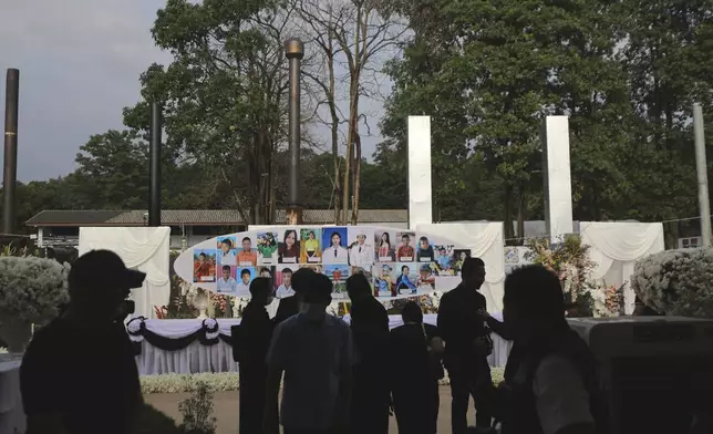 Portraits of victims of a school bus fire are placed in front of a cremation kiln at Wat Khao Phraya Sangkharam School, Lan Sak, Uthai Thani province, Thailand, Tuesday, Oct. 8, 2024. (AP Photo/Chatkla Samnaingjam)