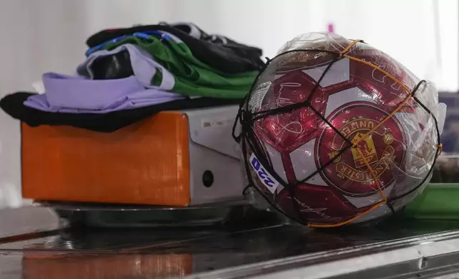 A newly purchased football is kept near the coffin of one of the victims of the school bus fire by father Wichan Seubsaichan, at Wat Khao Phraya Sangkharam School, Lan Sak, Uthai Thani province, Thailand, Thursday, Oct. 3, 2024. (AP Photo/Sakchai Lalit)