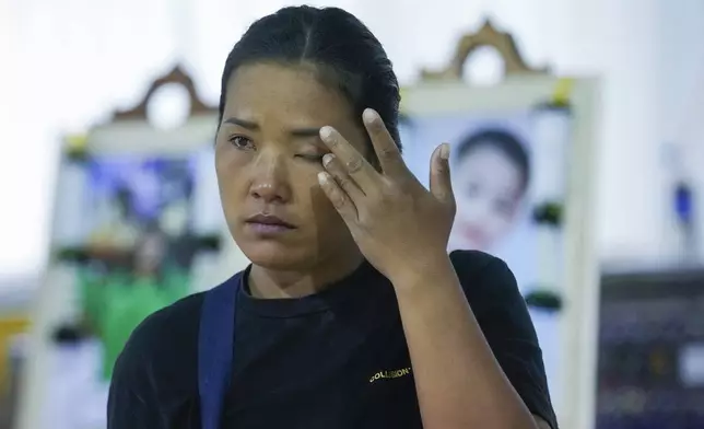 A relative of a victim of school bus fire cries at Wat Khao Phraya Sangkharam School, Lan Sak, Uthai Thani province, Thailand, Thursday, Oct. 3, 2024. (AP Photo/Sakchai Lalit)