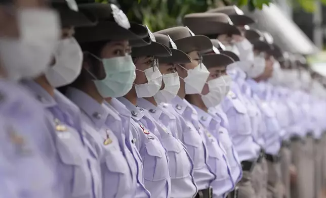 Nurse students pay respect to one of the victims of a school bus fire, at Police hospital in Bangkok, Thailand, Wednesday, Oct. 2, 2024. (AP Photo/Sakchai Lalit)