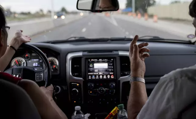 Husband and wife, Lesley, left, and Matt Dzik, argue about abortion as they drive through Champaign County, Ill., Saturday, Sept. 21, 2024. Sometimes for the Dziks knowing when to end the conversation is more important than winning it. “He’s not good at stopping but I’m getting better at walking away,” said Lesley. (AP Photo/David Goldman)