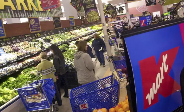 FILE - Shoppers look for groceries at a Kmart store in Bloomfield Hills, Mich., on Nov. 21, 2001. (AP Photo/Paul Sancya, File)