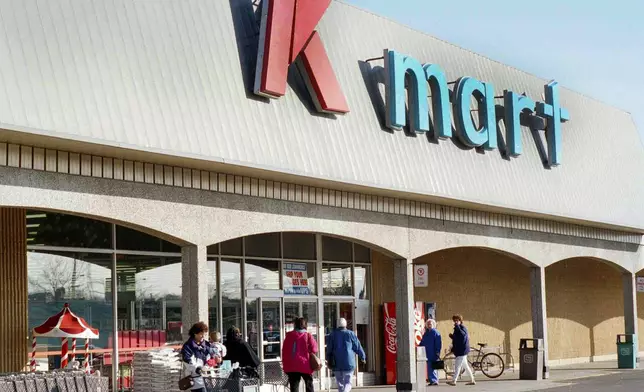 FILE - Kmart shoppers enter and leave the first Kmart ever built in Garden City, Mich., store, on Nov. 12, 1993. (AP Photo/Richard Sheinwald)