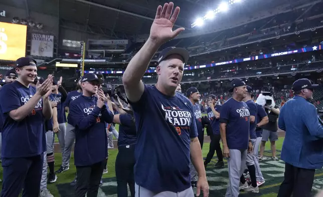 Detroit Tigers manager A.J. Hinch, center, celebrates his team's 5-2 win against the Houston Astros in Game 2 of an AL Wild Card Series baseball game Wednesday, Oct. 2, 2024, in Houston. (AP Photo/Kevin M. Cox)