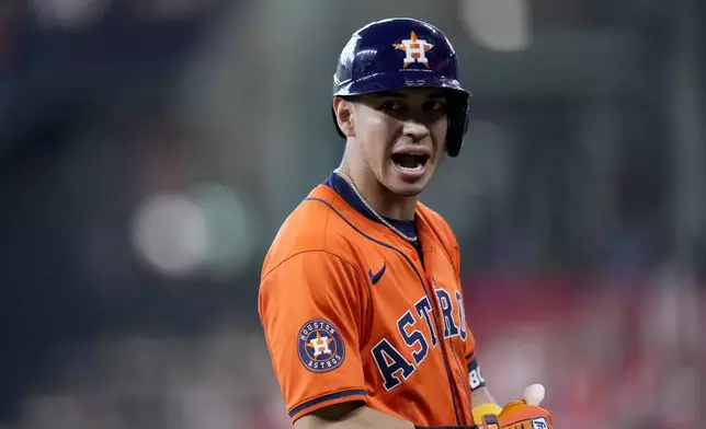 Houston Astros' Mauricio Dubon celebrates his bunt for a single against the Detroit Tigers in the seventh inning of Game 2 of an AL Wild Card Series baseball game Wednesday, Oct. 2, 2024, in Houston. (AP Photo/Kevin M. Cox)