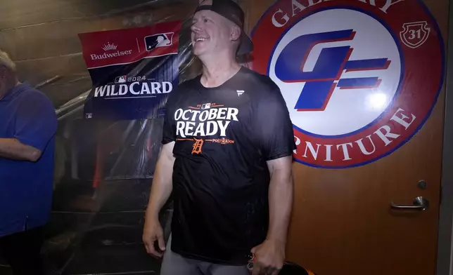 Detroit Tigers manager A.J. Hinch celebrates with his team in the clubhouse after defeating the Houston Astros in Game 2 to clinch the AL Wild Card baseball series, Wednesday, Oct. 2, 2024, in Houston. (AP Photo/Kevin M. Cox)