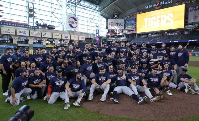 The Detroit Tigers pose for a team photo after their 5-2 win against the Houston Astros in Game 2 of an AL Wild Card Series baseball game Wednesday, Oct. 2, 2024, in Houston. (AP Photo/Kevin M. Cox)