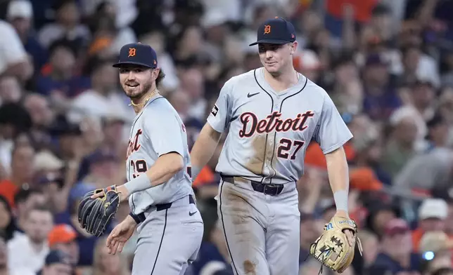 Detroit Tigers third baseman Zach McKinstry (39) and shortstop Trey Sweeney (27) celebrate after completing a double play that off a ground ball by Houston Astros' Yainer Diaz in the sixth inning of Game 2 of an AL Wild Card Series baseball game Wednesday, Oct. 2, 2024, in Houston. (AP Photo/Kevin M. Cox)