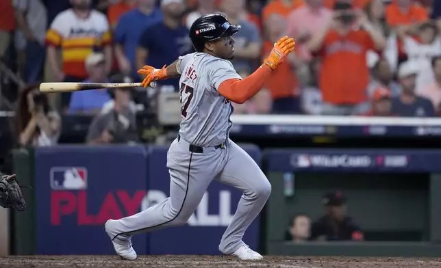 Detroit Tigers' Andy Ibanez follows through on a bases-clearing double against the Houston Astros in the eighth inning of Game 2 of an AL Wild Card Series baseball game Wednesday, Oct. 2, 2024, in Houston. (AP Photo/Kevin M. Cox)