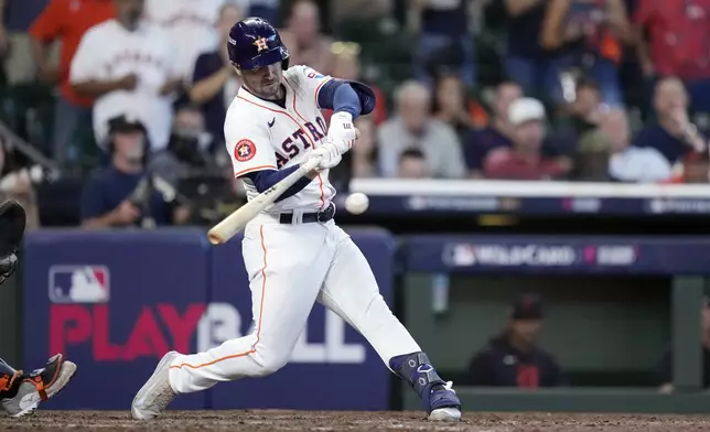 Houston Astros' Alex Bregman connects for an infield single to Detroit Tigers shortstop Trey Sweeney during the ninth inning of Game 1 of an AL Wild Card Series baseball game against the Detroit Tigers, Tuesday, Oct. 1, 2024, in Houston. (AP Photo/Kevin M. Cox)