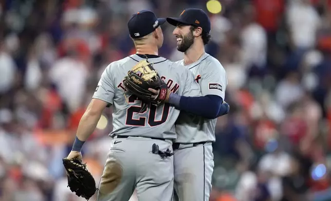 Detroit Tigers first baseman Spencer Torkelson (20) and third baseman Matt Vierling hug after the ninth inning of Game 1 of an AL Wild Card Series baseball game against the Houston Astros, Tuesday, Oct. 1, 2024, in Houston. (AP Photo/Kevin M. Cox)