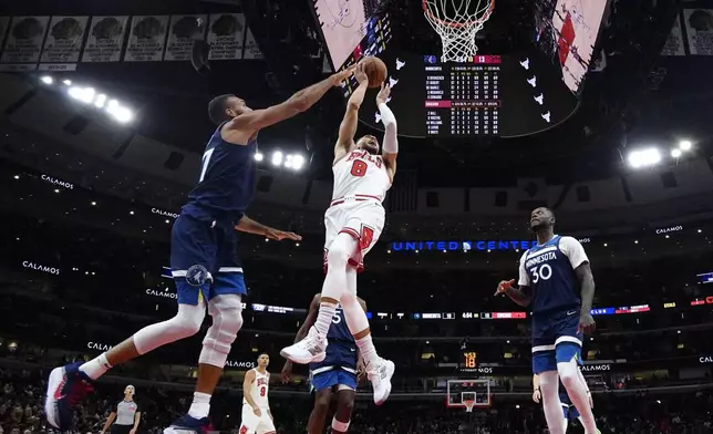 Chicago Bulls guard Zach LaVine (8) shoots against Minnesota Timberwolves center Rudy Gobert, left, as forward Julius Randle looks on during the first half of an NBA preseason basketball game in Chicago, Wednesday, Oct. 16, 2024. (AP Photo/Nam Y. Huh)