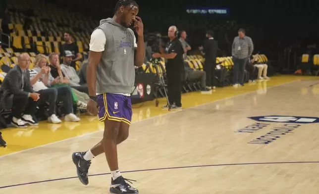 Los Angeles Lakers guard Bronny James warms up before an NBA basketball game against the Minnesota Timberwolves, Tuesday, Oct. 22, 2024, in Los Angeles. (AP Photo/Eric Thayer)