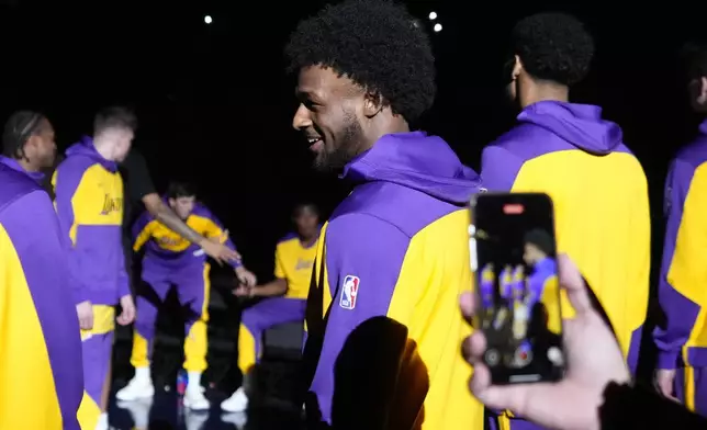 Los Angeles Lakers guard Bronny James stands on the court during introductions prior to a preseason NBA basketball game against the Minnesota Timberwolves, Friday, Oct. 4, 2024, in Palm Desert, Calif. (AP Photo/Mark J. Terrill)