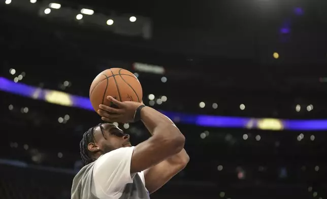 Los Angeles Lakers guard Bronny James warms up before an NBA basketball game against the Minnesota Timberwolves, Tuesday, Oct. 22, 2024, in Los Angeles. (AP Photo/Eric Thayer)