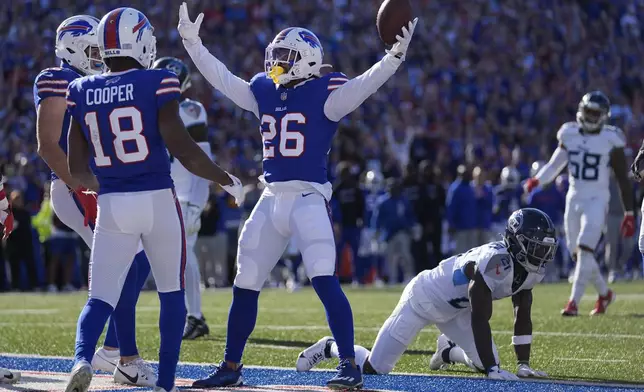 Buffalo Bills running back Ty Johnson (26) celebrates a touchdown against the Tennessee Titans with teammates during the second half of an NFL football game Sunday, Oct. 20, 2024, in Orchard Park, N.Y. (AP Photo/Charles Krupa)