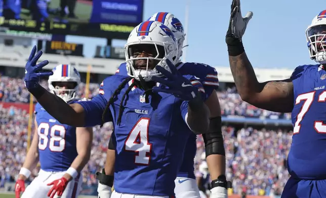 Buffalo Bills running back James Cook (4) celebrates a touchdown against the Tennessee Titans during the first half of an NFL football game Sunday, Oct. 20, 2024, in Orchard Park, N.Y. (AP Photo/Jeffrey T. Barnes)