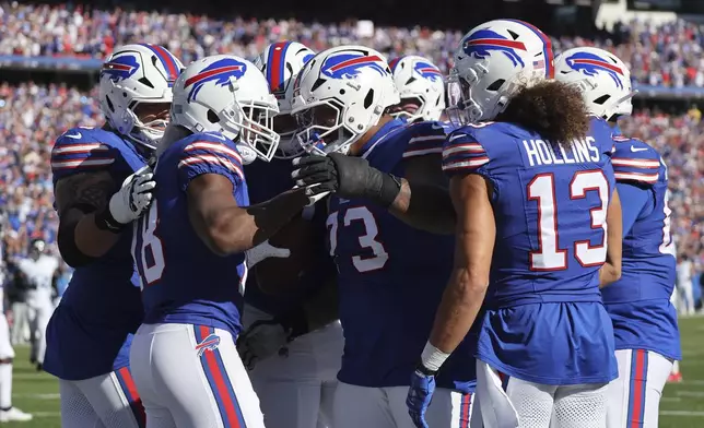 Buffalo Bills wide receiver Amari Cooper (18) celebrates his touchdown with teammates during the second half of an NFL football game against the Tennessee Titans, Sunday, Oct. 20, 2024, in Orchard Park, N.Y. (AP Photo/Jeffrey T. Barnes)