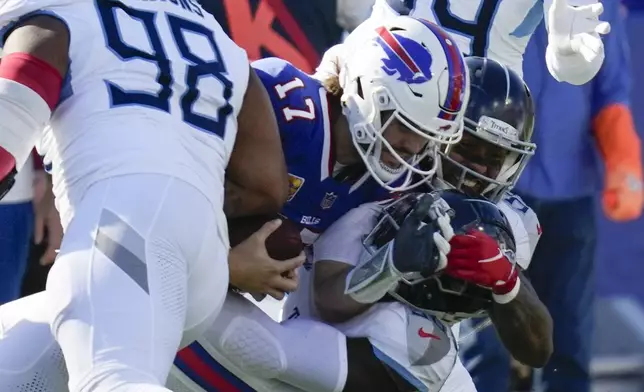 Buffalo Bills quarterback Josh Allen (17) is tackled by the Tennessee Titans defense during the first half of an NFL football game Sunday, Oct. 20, 2024, in Orchard Park, N.Y. (AP Photo/Charles Krupa)