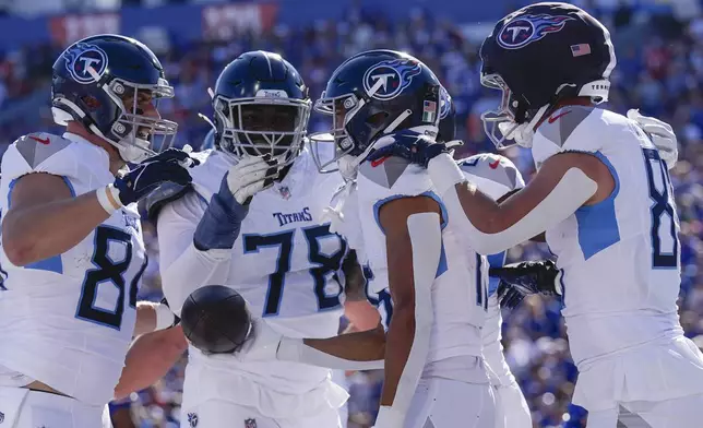 Tennessee Titans wide receiver Nick Westbrook-Ikhine, second from right, celebrates a touchdown with teammates during the first half of an NFL football game against the Buffalo Bills, Sunday, Oct. 20, 2024, in Orchard Park, N.Y. (AP Photo/Charles Krupa)