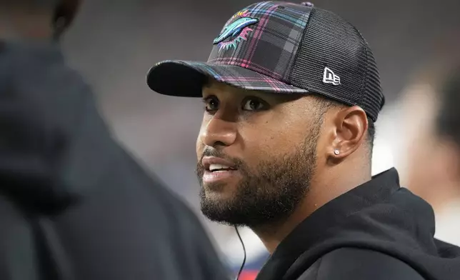 Miami Dolphins quarterback Tua Tagovailoa talks on the sidelines during the second half of an NFL football game against the Tennessee Titans, Monday, Sept. 30, 2024, in Miami Gardens, Fla. (AP Photo/Rebecca Blackwell)