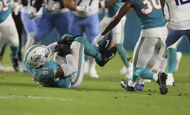 Miami Dolphins linebacker Emmanuel Ogbah (91) intercepts a pass during the first half of an NFL football game against the Tennessee Titans, Monday, Sept. 30, 2024, in Miami Gardens, Fla. (AP Photo/Brennan Asplen)