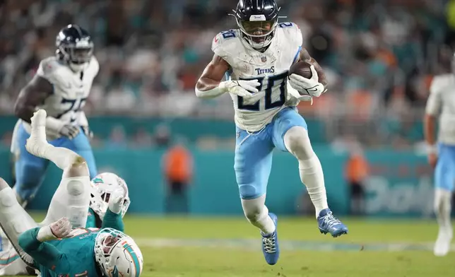 Tennessee Titans running back Tony Pollard (20) runs the ball during the first half of an NFL football game against the Miami Dolphins, Monday, Sept. 30, 2024, in Miami Gardens, Fla. (AP Photo/Rebecca Blackwell)