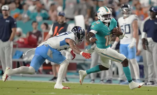 Tennessee Titans safety Amani Hooker (37) goes after Miami Dolphins quarterback Tyler Huntley (18) during the first half of an NFL football game, Monday, Sept. 30, 2024, in Miami Gardens, Fla. (AP Photo/Rebecca Blackwell)