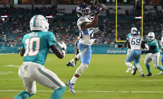 Tennessee Titans safety Quandre Diggs (28) intercepts a pass in the endzone intended for Miami Dolphins wide receiver Tyreek Hill (10) during the second half of an NFL football game, Monday, Sept. 30, 2024, in Miami Gardens, Fla. (AP Photo/Rebecca Blackwell)