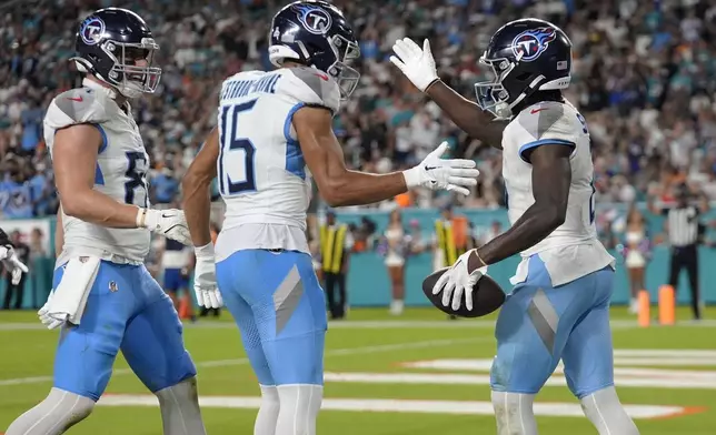 Tennessee Titans running back Tyjae Spears (2), right, celebrates his touchdown during the second half of an NFL football game against the Miami Dolphins, Monday, Sept. 30, 2024, in Miami Gardens, Fla. (AP Photo/Rebecca Blackwell)