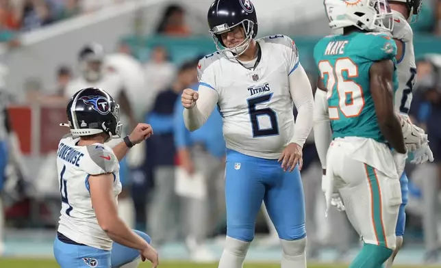 Tennessee Titans place kicker Nick Folk (6) celebrates a field goal with punter Ryan Stonehouse (4) during the second half of an NFL football game against the Miami Dolphins, Monday, Sept. 30, 2024, in Miami Gardens, Fla. (AP Photo/Rebecca Blackwell)