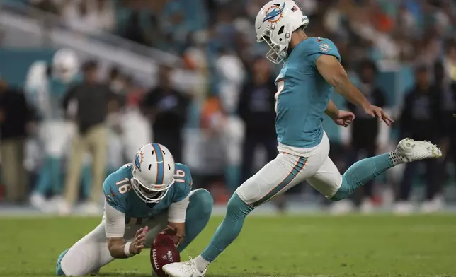 Miami Dolphins place kicker Jason Sanders (7) kicks a field goal as punter Jake Bailey (16) holds the ball during the first half of an NFL football game against the Tennessee Titans, Monday, Sept. 30, 2024, in Miami Gardens, Fla. (AP Photo/Brennan Asplen)