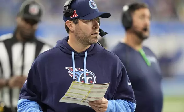 Tennessee Titans head coach Bria Callahan looks onto the field during the second half of an NFL football game against the Detroit Lions, Sunday, Oct. 27, 2024, in Detroit. (AP Photo/Carlos Osorio)