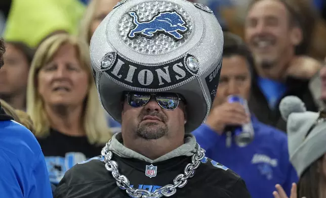 A Detroit Lions fan watches during the second half of an NFL football game against the Tennessee Titans, Sunday, Oct. 27, 2024, in Detroit. (AP Photo/Paul Sancya)