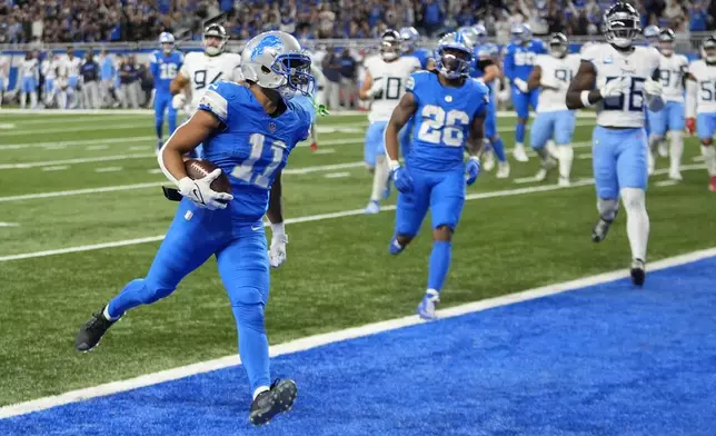 Detroit Lions wide receiver Kalif Raymond (11) scores a touchdown against the Tennessee Titans during the second half of an NFL football game Sunday, Oct. 27, 2024, in Detroit. (AP Photo/Paul Sancya)