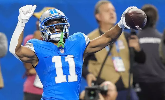 Detroit Lions wide receiver Kalif Raymond (11) celebrates his touchdown during the second half of an NFL football game against the Tennessee Titans, Sunday, Oct. 27, 2024, in Detroit. (AP Photo/Carlos Osorio)