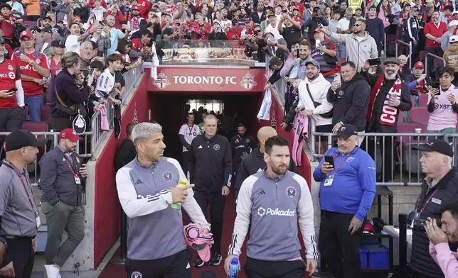 Fans looks on as Inter Miami forward Lionel Messi, front right, and Luis Suárez make their way to the sidelines before the start of an MLS soccer match against Toronto FC in Toronto Saturday Oct. 5, 2024. (Chris Young/The Canadian Press via AP)