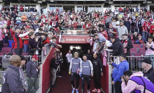 Fans looks on as Inter Miami forward Lionel Messi, front right, and Luis Suárez make their way to the sidelines before the start of an MLS soccer match against Toronto FC in Toronto Saturday Oct. 5, 2024. (Chris Young/The Canadian Press via AP)