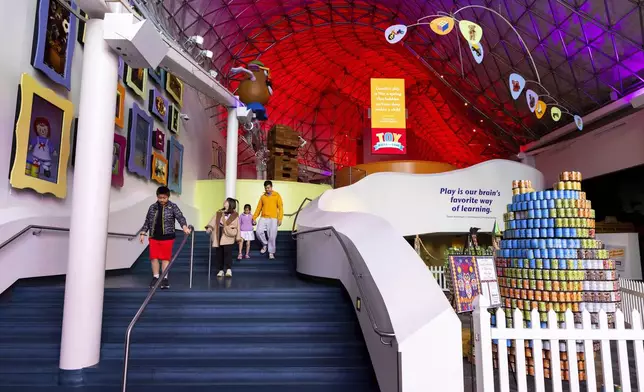 Visitors walk through the Toy Hall of Fame inside The Strong National Museum of Play, Tuesday, Oct. 15, 2024, in Rochester, N.Y. (AP Photo/Lauren Petracca)