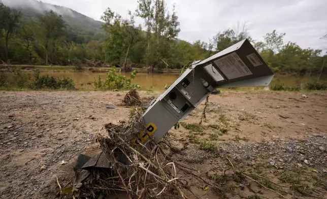 An electrical box is damaged after flash flooding in the aftermath of Hurricane Helene, Tuesday, Oct. 1, 2024, in Swannanoa, N.C. (AP Photo/Mike Stewart)