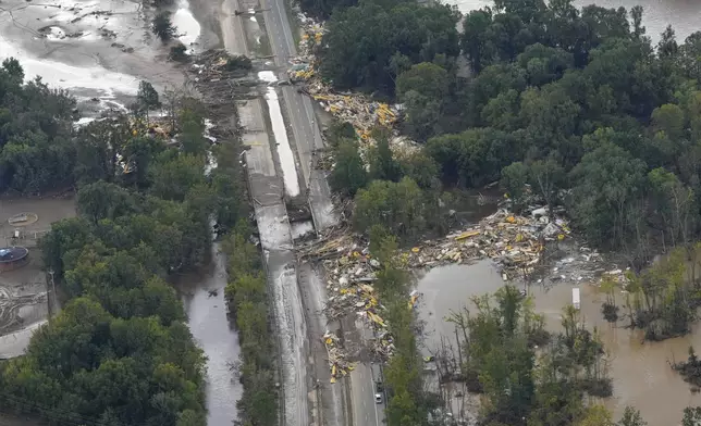 An aerial view of flood damage in the aftermath of Hurricane Helene, Saturday, Sept. 28, 2024, in Erwin, Tenn. (AP Photo/George Walker IV)