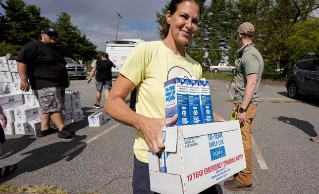 Volunteers stage water for citizens in the aftermath of Hurricane Helene, Monday, Sept. 30, 2024, in Asheville, N.C. (AP Photo/Mike Stewart)