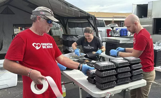 Volunteers for Operation BBQ Relief prepare meals for people without power or water, Oct. 1, 2024, in Augusta, Georgia. (AP Photo / Jeffrey Collins)