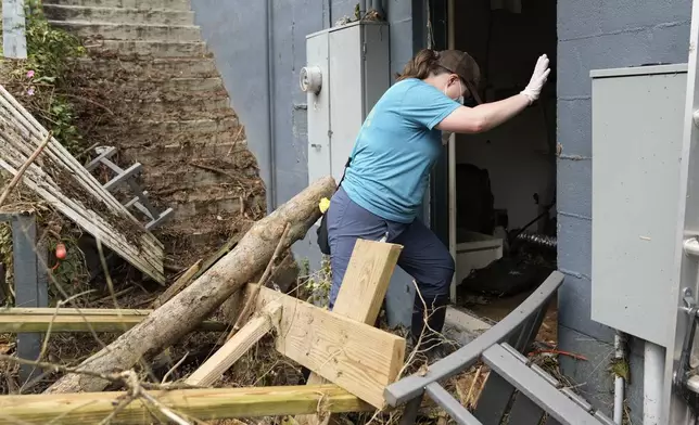 Sarah Calloway enters her restaurant to assess the damage left in the wake of Hurricane Helene Tuesday, Oct. 1, 2024, in Hot Springs, N.C. (AP Photo/Jeff Roberson)